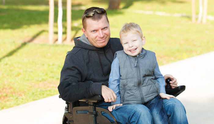 man with long term disability insurance with son at park