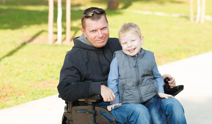 man with long term disability insurance with son at park