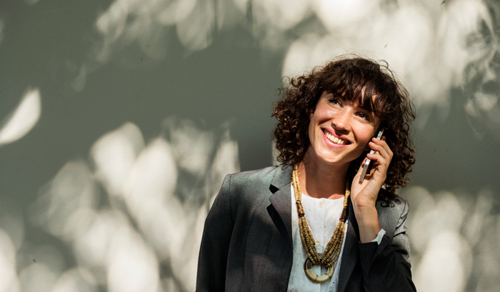 professional woman on phone outside smiling